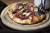 Pizza with figs, serrano ham and balsamic
