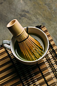 Preparing matcha tea with bamboo whisk