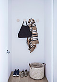 Simple hall coat rack with round wall hooks in a niche