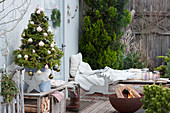 Christmas terrace with sugar loaf spruce and fire bowl