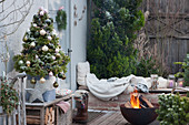 Christmas terrace with sugar loaf spruce and fire bowl