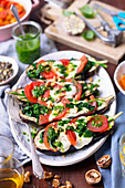 Eggplants baked with mozzarella, spinach and tomatoes