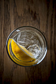 Water with ice and lemon wedge from top