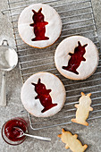 Jam cookies with Easter bunny motifs on a cooling grid