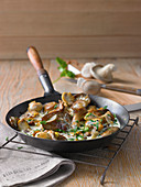 Mushrooms in a pan with cream cheese and parsley
