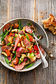 Sausage salad with mushrooms and colourful vegetables