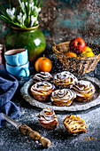 Buns with roses from apples, sprinkled with powdered sugar