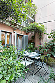 Seating area on Mediterranean terrace behind house