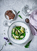Asparagus stock with wild garlic and semolina dumplings and peas