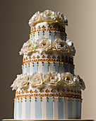 Easter Celebrations, three tiered white and teal striped wedding cake with camelia sugared flowers