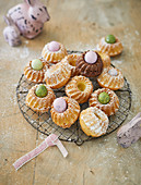 Mini Bundt cakes on a wire rack with coloured quail's eggs and Easter decorations
