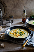 Cream of jerusalem soup with chilli oil, parmesan crisps and parsley
