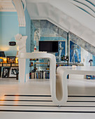 Curved designer table in extravagant blue interior with mirrored wall and contemporary stucco ornamentation