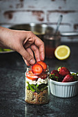 Bulgur salad with green asparagus, feta cheese and strawberries in a jar