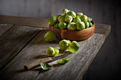 Brussels sprouts in a wooden bowl with a peeler