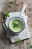 Cream of herb soup in a saucepan