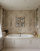 Fitted bathtub with panelled cladding in classic bathroom