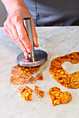 Brittle being cut out and flattened