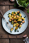 Fried vegan gnocchi with smoked tofu and spinach