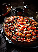 A tomato and olive pizza