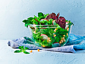 A mixed leaf salad with chickpeas and radishes
