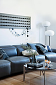 Wall decor with bars above the black leather sofa