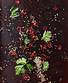 A dressing with sesame seeds, chilli and coriander