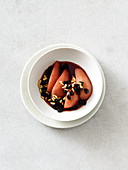 Honey pears with cherries and pine nuts