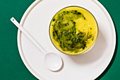 Cream of potato and parsley soup with rocket pesto