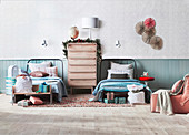 Christmas-decorated chest of drawers between two beds, surrounded by Christmas presents