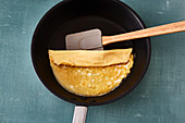 A sweet omelette being folded in a pan (Japan)