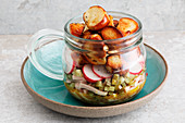 Pretzel salad with yellow sausage and radishes