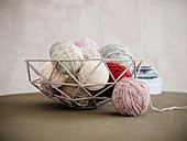 A basket of various knitting yarns