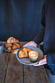 Croissants with a cappuccino on a plate
