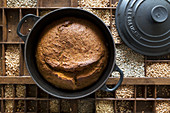 Bread, baked in a cast-iron pot, on a set of different grains