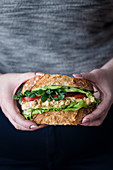 Sandwich with chickpea salad, avocado, tomato and lettuce