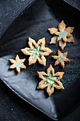 Snowflake shortbread biscuits with vanilla soy cream and blue powdered sugar (vegan)