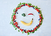 A smiling face made from fruit and vegetables