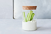 Celery sticks with a blue cheese dip in a jar