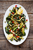 Fried dandelions with lemon, chili and capers
