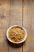 Soya flakes in a wooden bowl