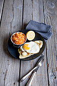 Turkey escalope with mozzarella and a fried egg, served with a root vegetable salad