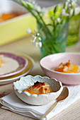 Baked apricots with almonds on vanilla ice cream