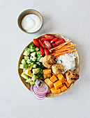 A Buddha bowl with falafel, rice and yoghurt dip