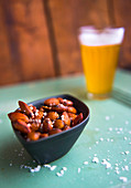 Rosted Almonds with salt flakes glass of beer