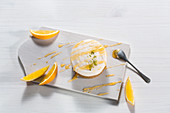Orange tarts with orange sauce and citrus slices