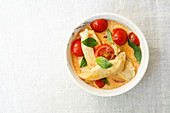 Red chicken curry with cherry tomatoes