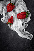 Red and fresh strawberries flat lay in a piece of cloth