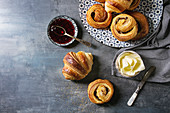 Homemade puff pastry buns, cinnamon rolls and croissant served with jam, butter as breakfast
