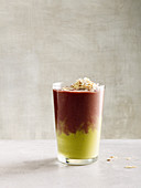 Red and green layered drink with figs, grapes and pistachio nuts